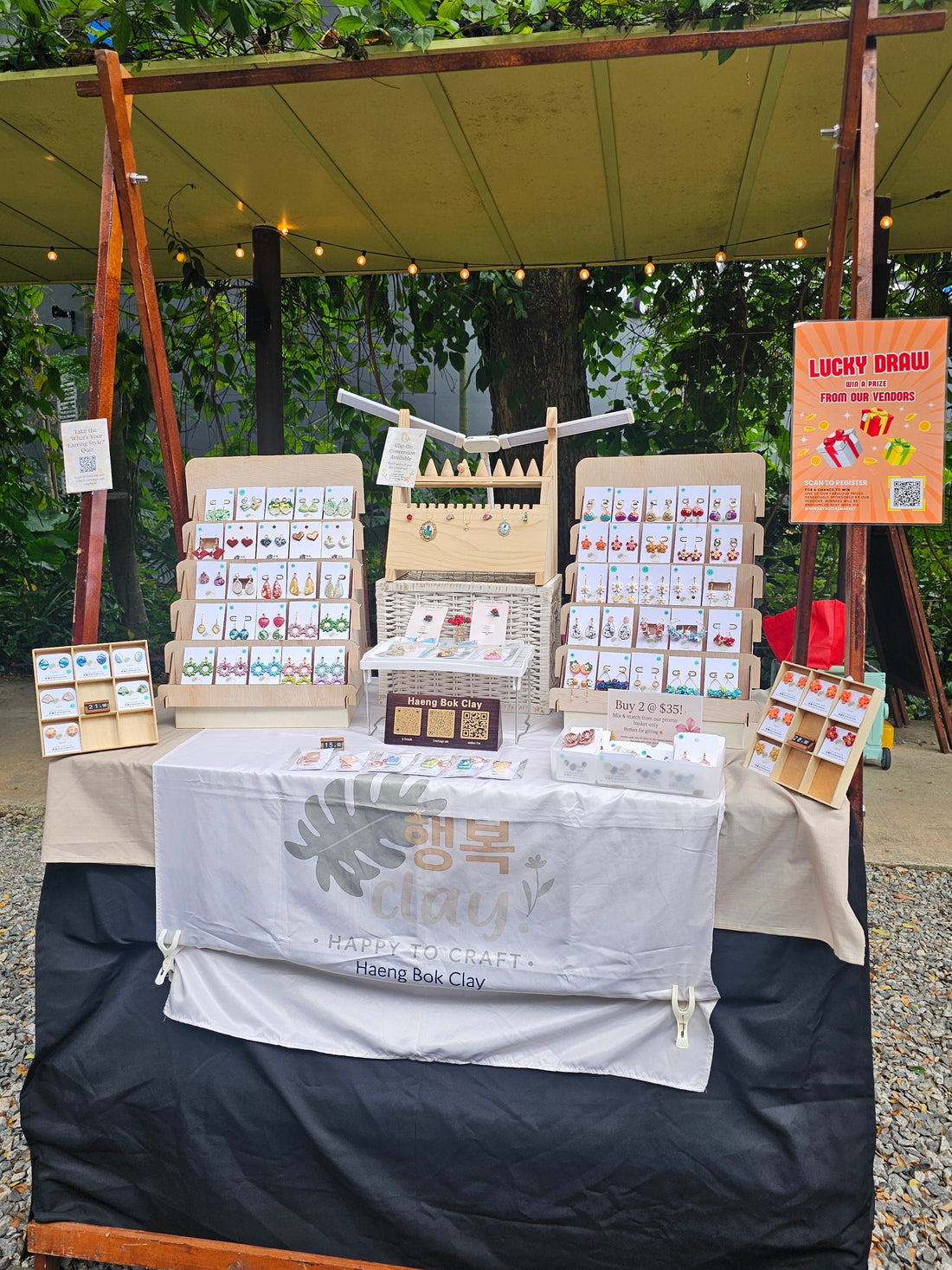 Haeng Bok Clay jewellery booth display at Sunday Socials Sentosa Festive Market featuring handcrafted earrings and accessories