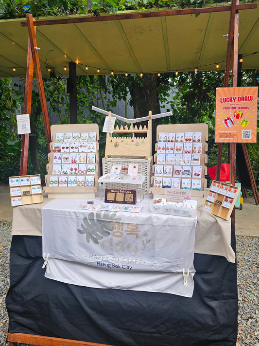 Haeng Bok Clay jewellery booth display at Sunday Socials Sentosa Festive Market featuring handcrafted earrings and accessories