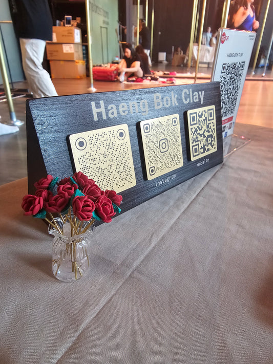 Haeng Bok Clay booth signage with QR codes and rose display at Chinese New Year art market at The Brass Barre Singapore
