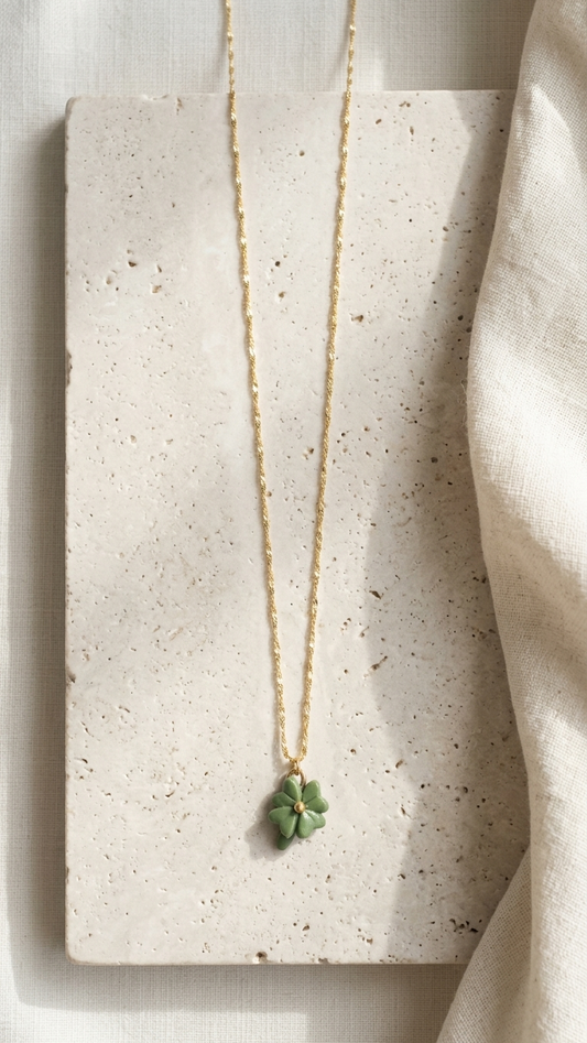 Necklace with a green pendant on a textured stone surface