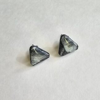 Handcrafted polymer clay triangular stud earrings with charcoal and silver shimmer on a neutral background