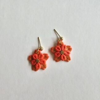 Handcrafted polymer clay coral floral drop earrings with gold accents and gold-plated stainless steel ball studs on a light background