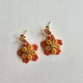 Handcrafted polymer clay floral drop earrings with caramel and coral petals and frosted 18K gold plated copper stud posts on a light background