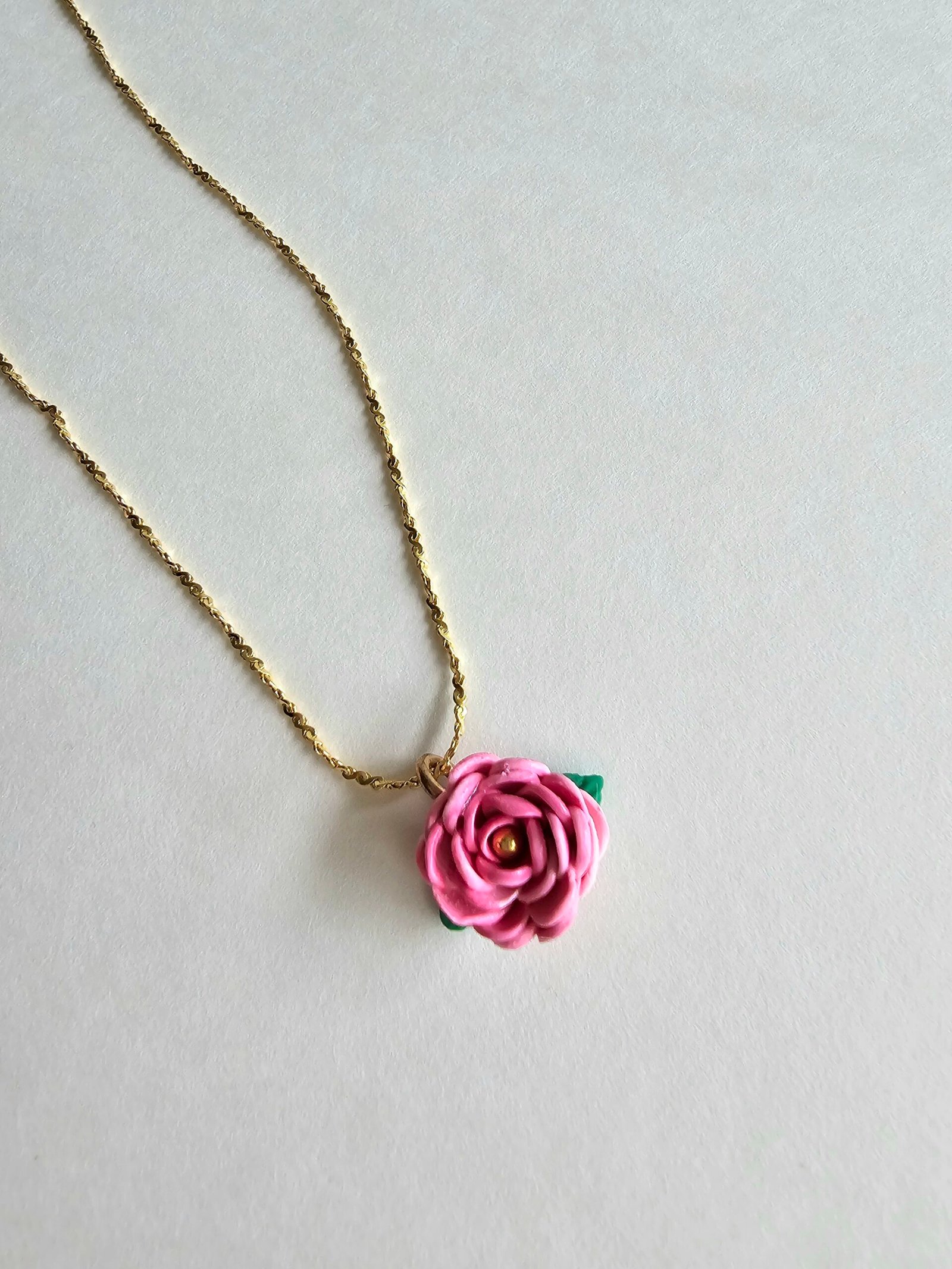 Gold plated 925 silver necklace with a handmade pink polymer clay rose charm and subtle green leaf detail