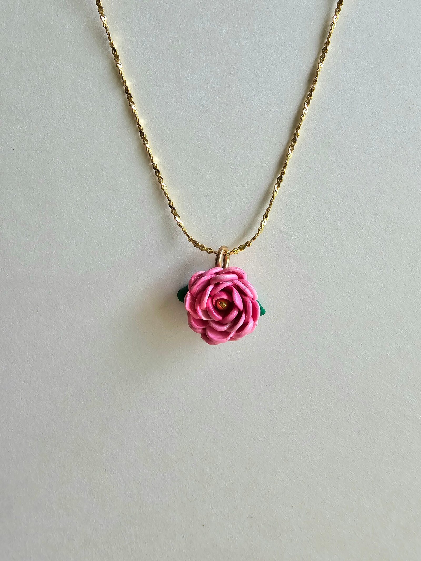 Gold plated 925 silver necklace with a handmade pink polymer clay rose charm and subtle green leaf detail
